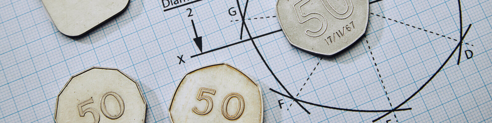 Picture of mathematical diagrams for an equilateral curved heptagon with trial 50p coins of different shapes laid on top