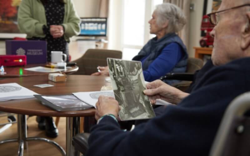 Residents interacting with the Reminiscence Box in Bryn Ivor Lodge, Newport