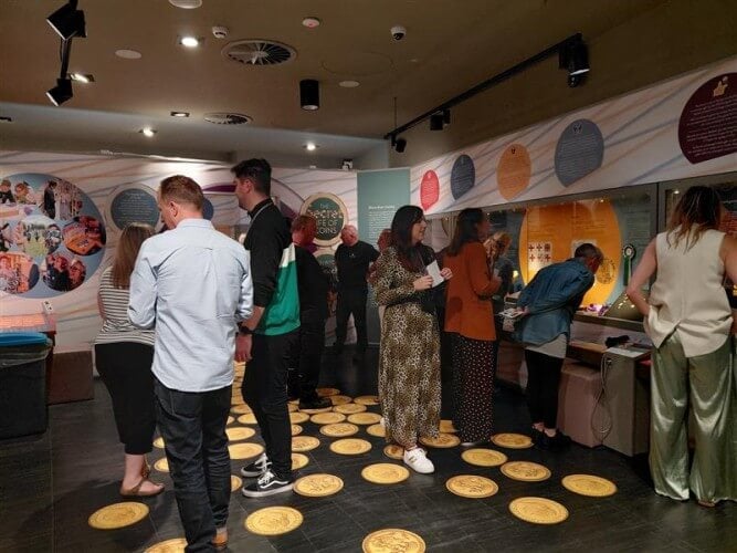 Picture of people in The Secret Life of Coins exhibition in the Royal Mint Experience