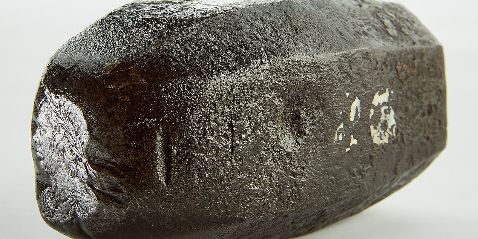 A metal punch with a portrait of Oliver Cromwell made for making coinage dies