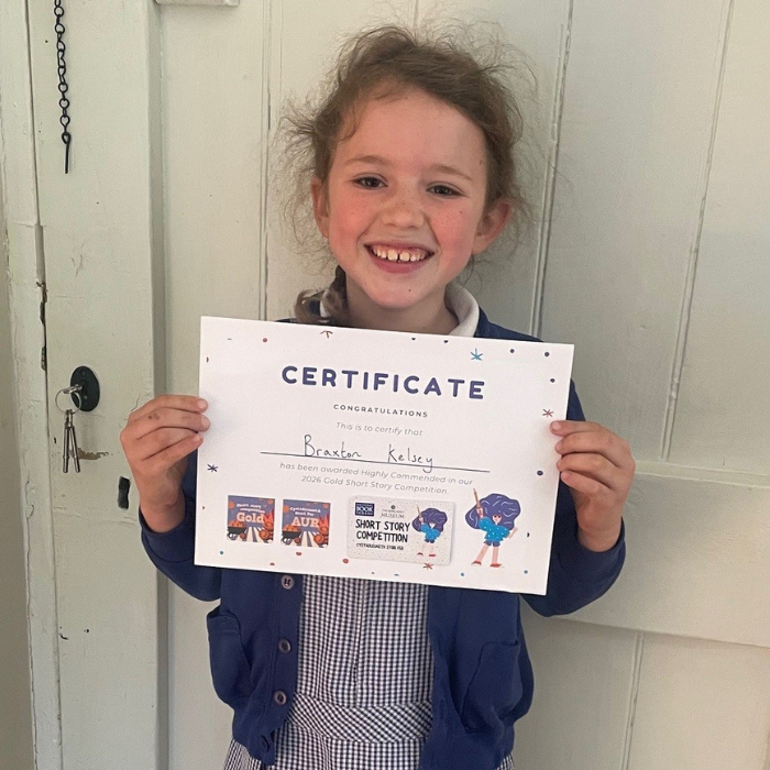 Braxton holding a certificate and prize