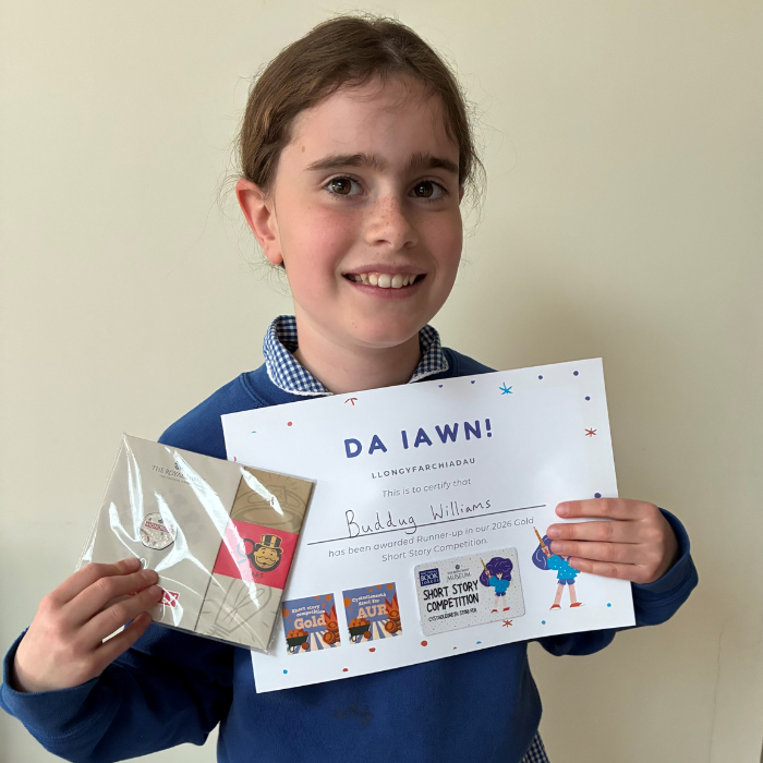 Buddug holding the certificate and prize
