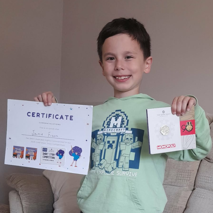Jamie holding the certificate and prize