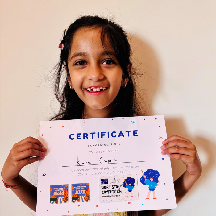 Kiara holding the certificate and prize