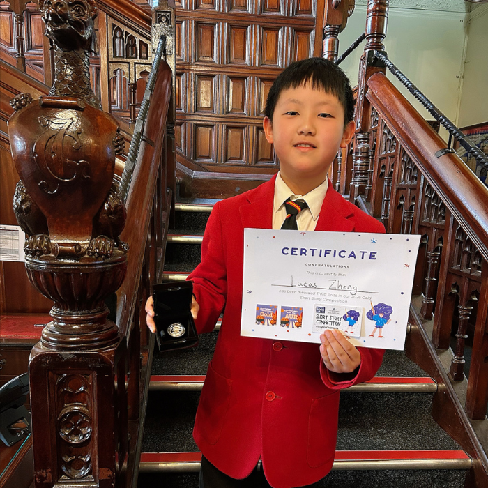 Lucas holding a certificate and prize