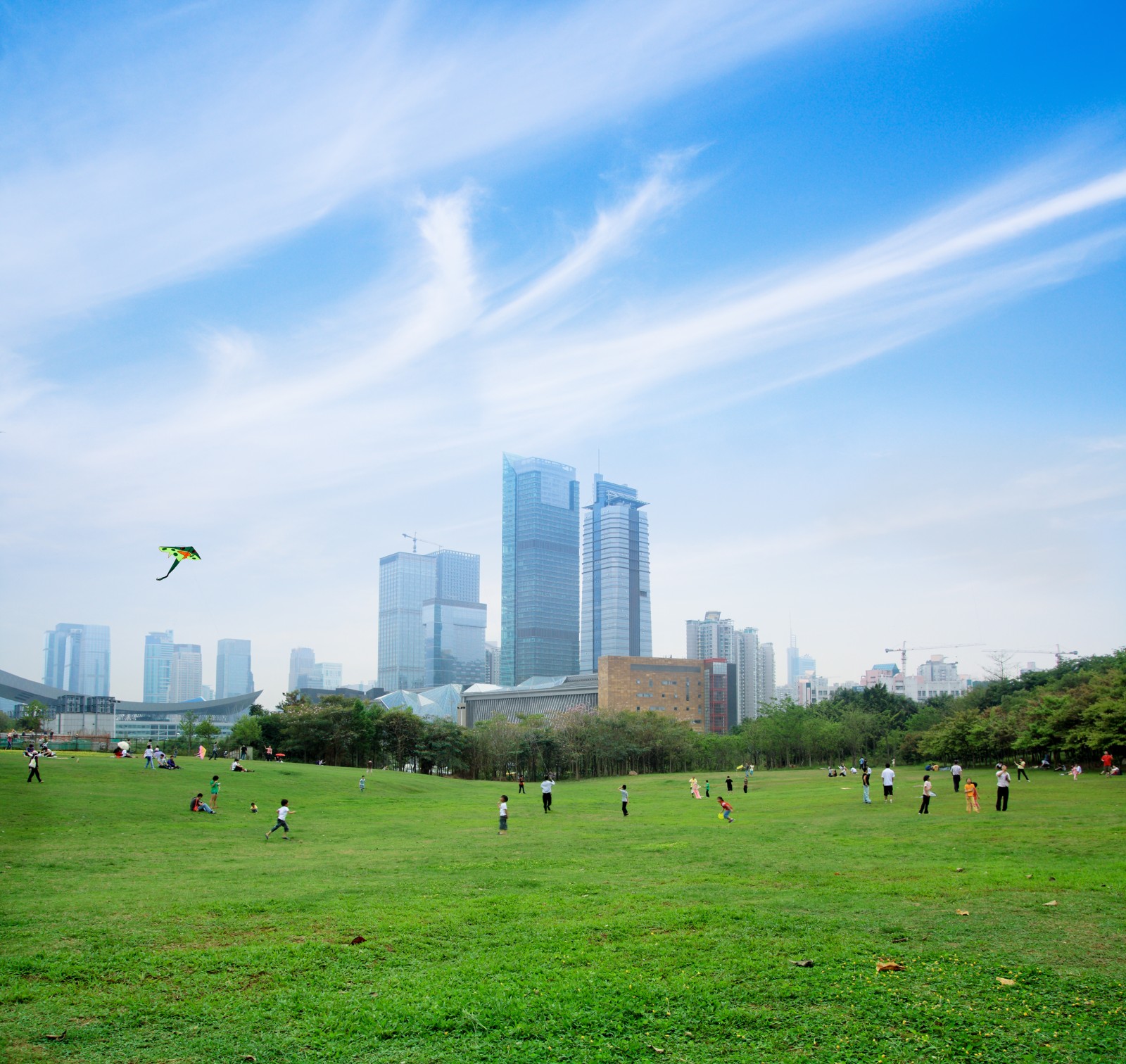 A city with children playing in a park