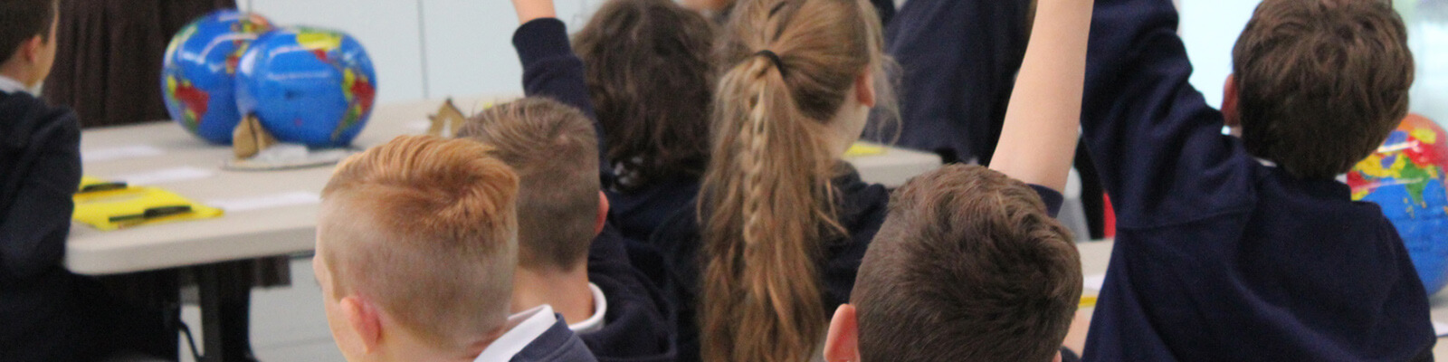 A photograph of children taking part in a school workshop at the Royal Mint Experience