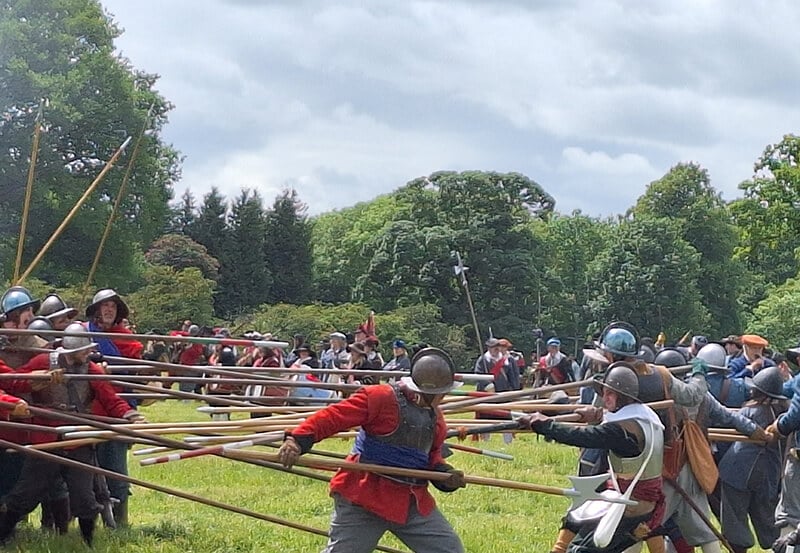 Members of the Sealed Knot re-enactment society in Civil War costume re-enacting the Battle of Naseby. There are two sides fighting with long wooden pikes