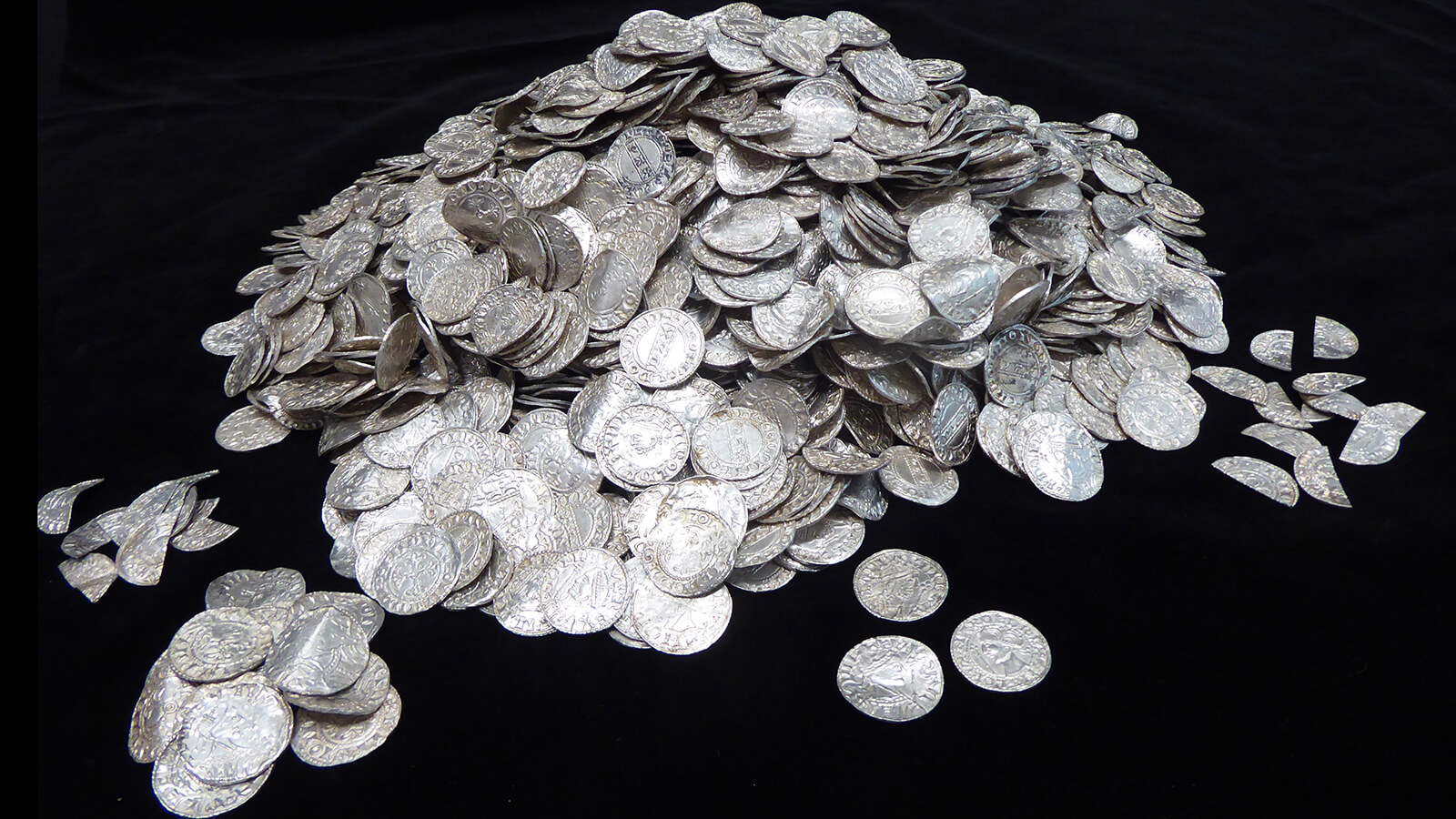 A large collection of silver coins in a pile