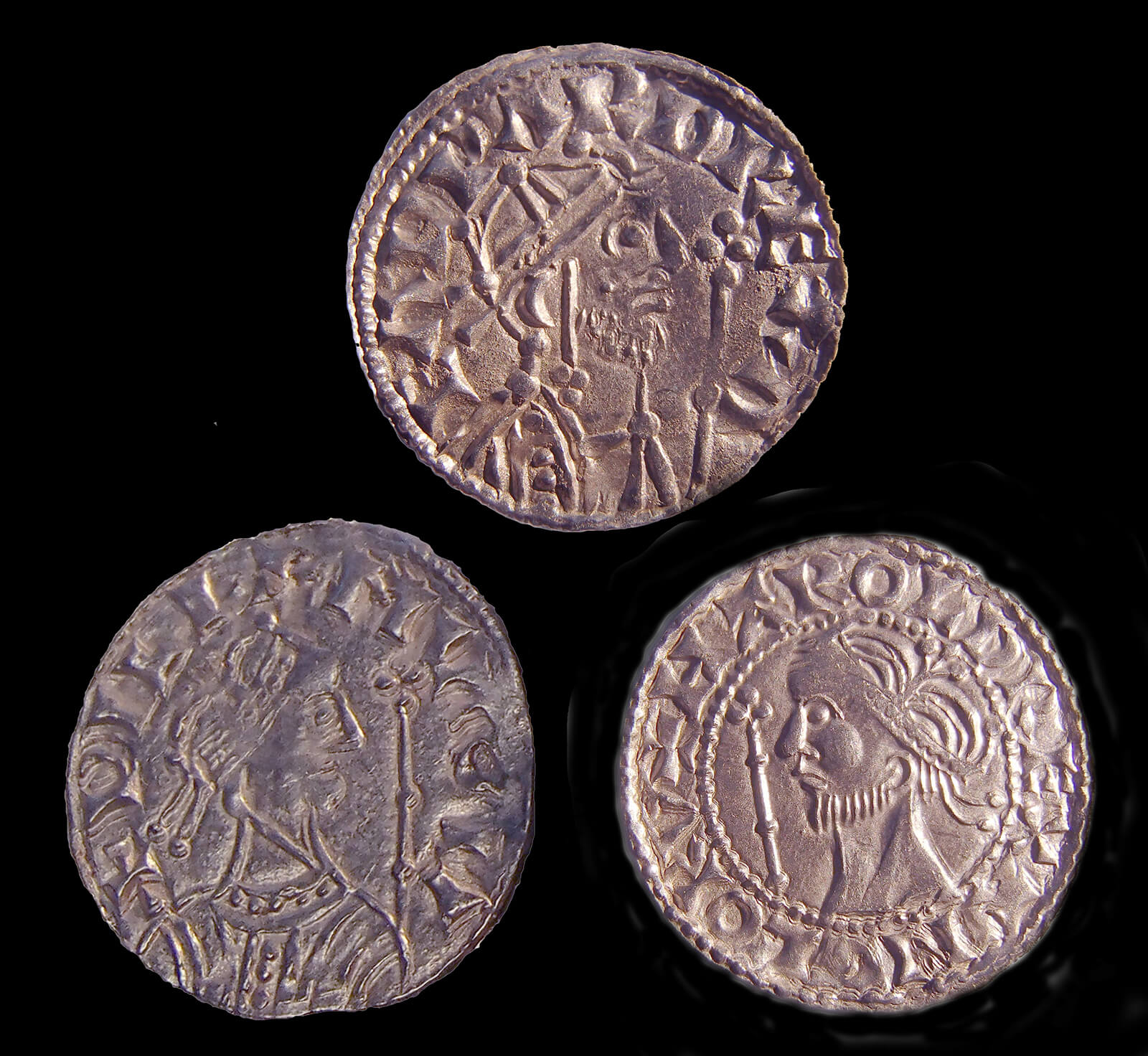 Three silver coins. Each bears a different picture of a monarch