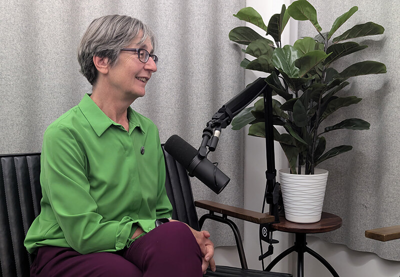 Two people standing looking down at archaeological artefacts on a shelf