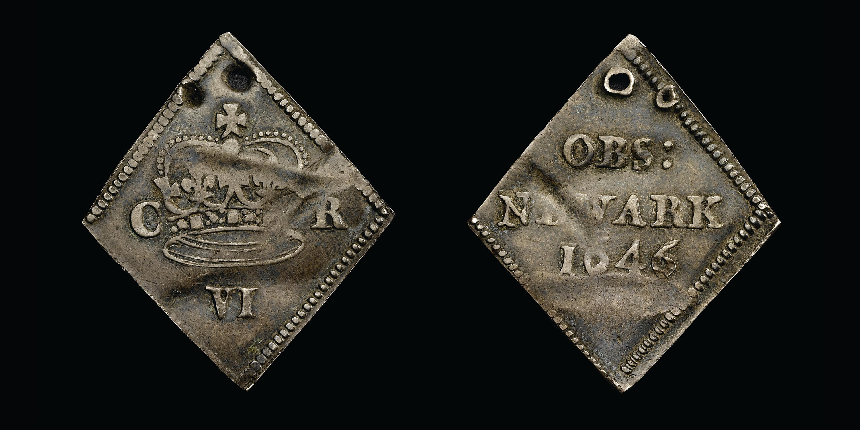 A diamond shaped silver token with a crown and the initials C R stamped on one side and the word NEWARK on the other